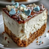 Sliced Candy Hearts Fake Cake reveals silky cream cheese filling on a buttery graham cracker crust.