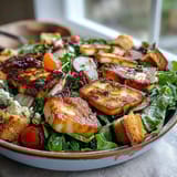 Golden-fried halloumi and blood orange slices top a colorful salad bowl, with sourdough croutons and fresh greens for a vibrant Halloumi Blood Orange Fattoush.