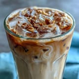 Creamy iced oat milk espresso drink with rich brown sugar syrup, ice cubes, and a hint of cinnamon for a sweet, spiced flavor.