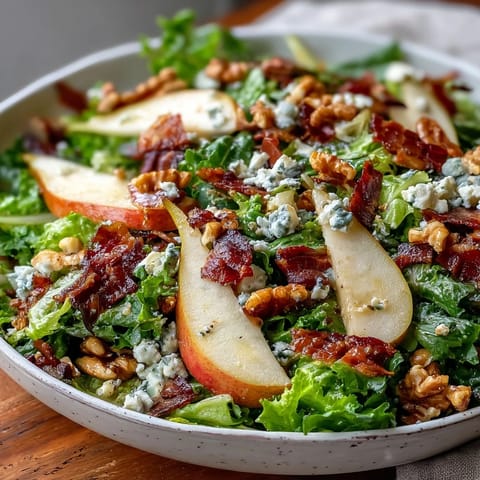 Frisée Pear Blue Cheese Bowl with crispy prosciutto and toasted walnuts tossed in vinaigrette.